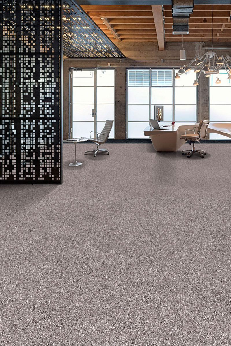 Modern office interior with a desk, chairs, and large windows.