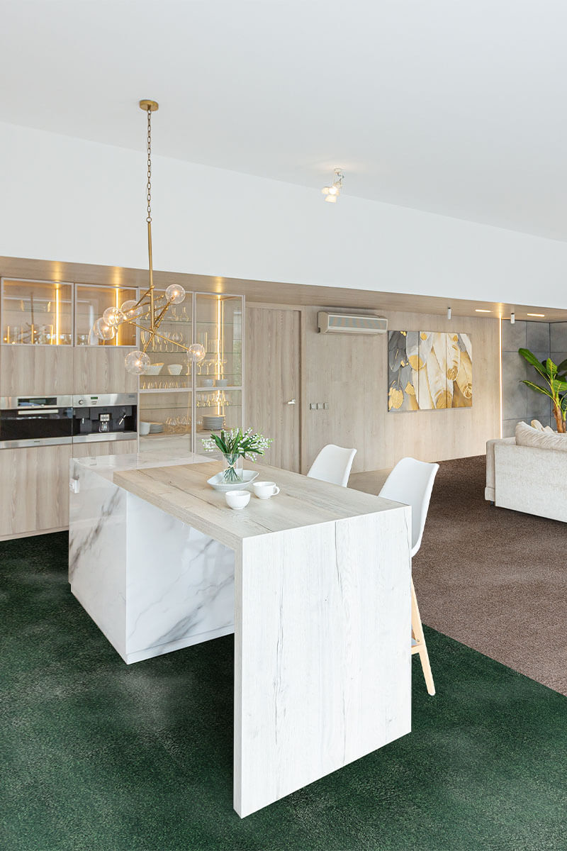 Modern kitchen with a marble island and white chairs