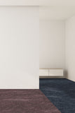 Minimalist room with a white wall, gray carpet, and a small wooden cabinet.